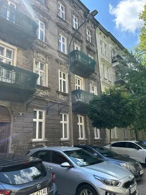 a building with cars parked in front of it at Vintage Charm in Old Town Krakow Józefa Sarego apt A in Kraków