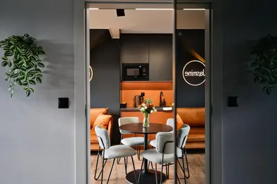 a kitchen and dining room with a table and chairs at Jasmine by Housine in Zator
