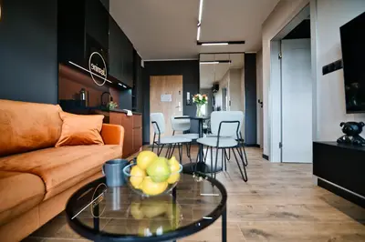 a living room with a couch and a table and chairs at Jasmine by Housine in Zator