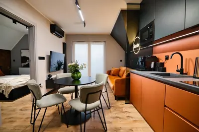 a kitchen and living room with a table and chairs at Jasmine by Housine in Zator
