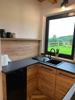 a kitchen with a sink and a window at Chatki u Atki - Zawada Lanckorońska in Zakliczyn