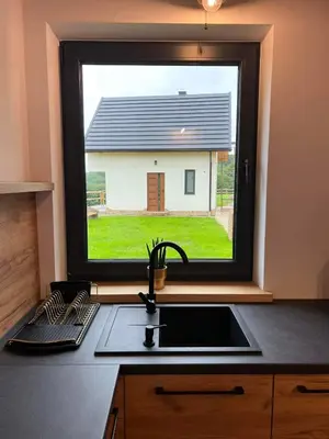 a kitchen with a sink and a window over a counter at Chatki u Atki - Zawada Lanckorońska in Zakliczyn