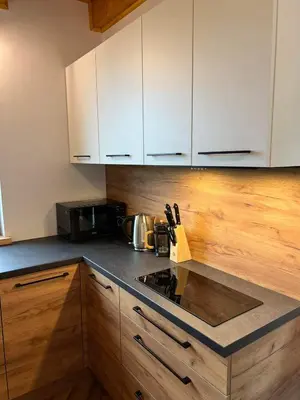 a kitchen with white cabinets and a stove top oven at Chatki u Atki - Zawada Lanckorońska in Zakliczyn