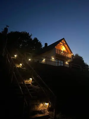 a house with lights on the side of it at night at Chatki u Atki - Zawada Lanckorońska in Zakliczyn