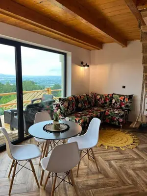 a living room with a couch and a table and chairs at Chatki u Atki - Zawada Lanckorońska in Zakliczyn