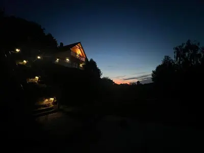 a house lit up at night with lights on it at Chatki u Atki - Zawada Lanckorońska in Zakliczyn