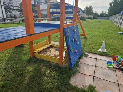 a playground with a slide in a yard at Energylandia Domki-Apartamenty u Agi G in Zator