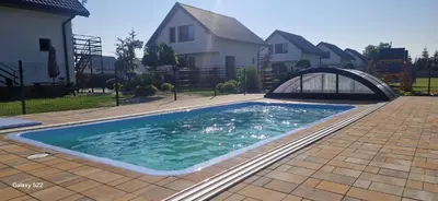 a swimming pool in front of a house at Energylandia Domki-Apartamenty u Agi G in Zator