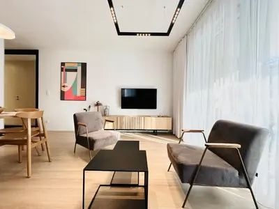 a living room with chairs and a tv and a table at Stare Miasto z widokiem na ogród, bezpłatny parking, szybkie Wi-Fi in Kraków