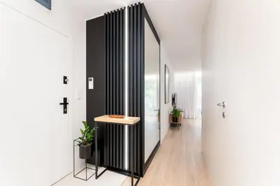 a hallway with a console table in a house at Stare Miasto z widokiem na ogród, bezpłatny parking, szybkie Wi-Fi in Kraków