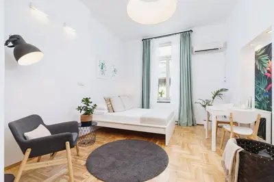 a living room with a white couch and a table at Private Parking - Old Town - Św Krzyża 16 Street in Kraków