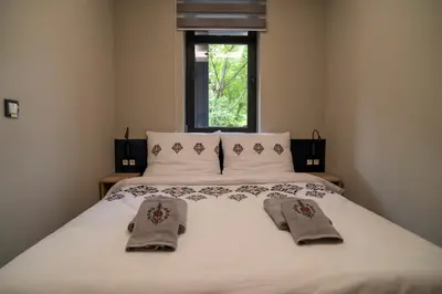 a bedroom with a bed with two towels on it at Władysławka in Rabka-Zdroj