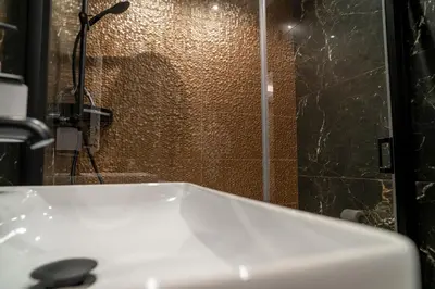 a bathroom with a white sink and a shower at Władysławka in Rabka-Zdroj