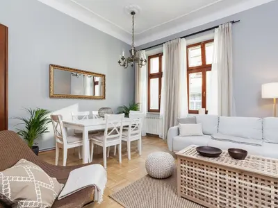 a living room with a white couch and a table at Main Square Apartment - Private Parking - Św Krzyża 16 in Kraków