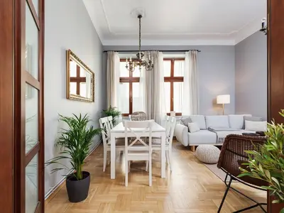 a living room with a table and a couch at Main Square Apartment - Private Parking - Św Krzyża 16 in Kraków