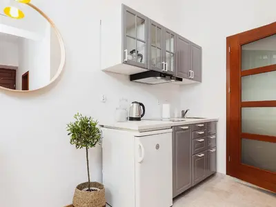 a kitchen with a sink and a mirror at Main Square Apartment - Private Parking - Św Krzyża 16 in Kraków