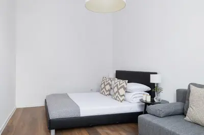a living room with a bed and a couch at 2-Bedroom Apartment - Długa 65 Street in Kraków