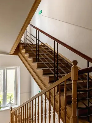 a winding staircase in a house with a window at 1-bedroom apartment - Długa 65 street in Kraków