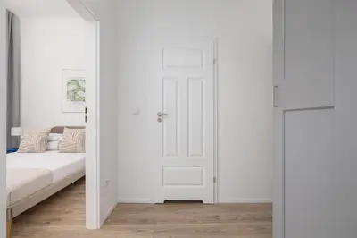 a bedroom with a bed and a white door at 2 Bedroom Apartment - Długa 65 in Kraków