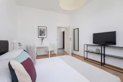 a bedroom with a bed and a flat screen tv at 1-Bedroom Apartment - Długa 65 Street in Kraków