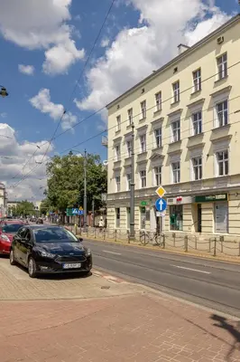 a black car parked in front of a building at 1-Bedroom Apartment - Długa 65 Street in Kraków