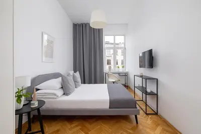 a bedroom with a bed and a window at 2-Bedroom Apartment with Balcony - Długa 65 in Kraków
