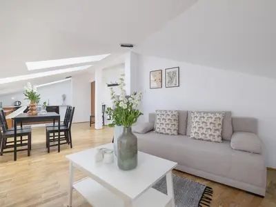 a living room with a couch and a table at Studio apartment with AC - Długa 65 street in Kraków