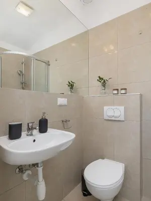 a bathroom with a sink and a toilet at Studio apartment with AC - Długa 65 street in Kraków