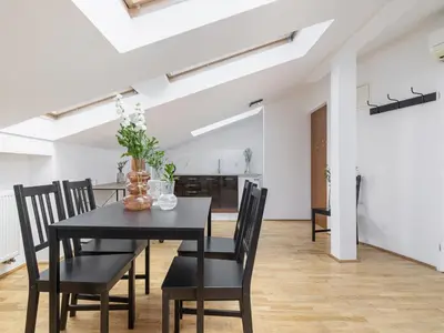 a dining room with a black table and chairs at Studio apartment with AC - Długa 65 street in Kraków