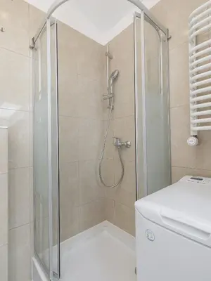 a shower in a bathroom with a glass shower backdoor at Studio apartment with AC - Długa 65 street in Kraków