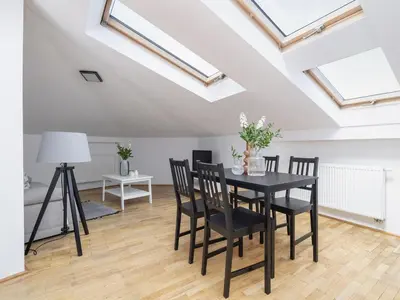a dining room with skylights and a table and chairs at Studio apartment with AC - Długa 65 street in Kraków