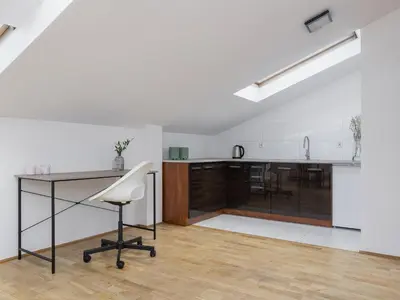 a kitchen with a desk and a chair in a room at Studio apartment with AC - Długa 65 street in Kraków