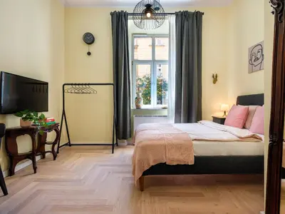 a bedroom with a bed and a window at Yellow Studio - Kochanowskiego in Kraków