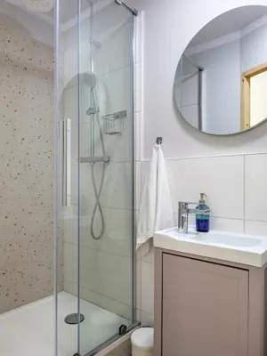 a bathroom with a shower and a sink and a mirror at Yellow Studio - Kochanowskiego in Kraków