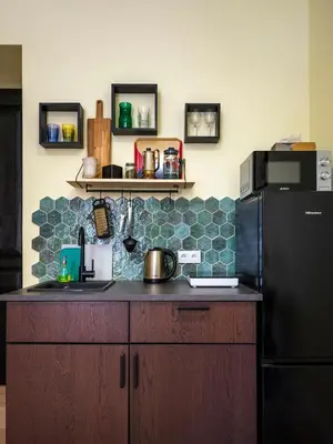 a kitchen with a black refrigerator and a counter at Yellow Studio - Kochanowskiego in Kraków