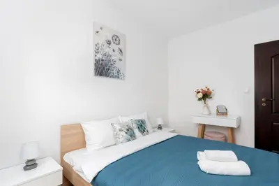 a bedroom with a bed with a blue blanket at Przewóz Comfort Apartment by BookingHost in Kraków