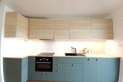a kitchen with blue cabinets and a sink at Old Town Apartments - Kącik 18 in Kraków