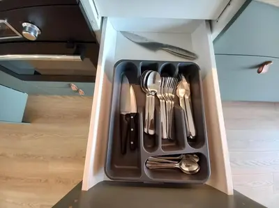 a drawer filled with utensils in a cabinet at Old Town Apartments - Kącik 18 in Kraków