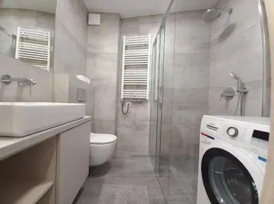 a bathroom with a sink and a washing machine at Old Town Apartments - Kącik 18 in Kraków