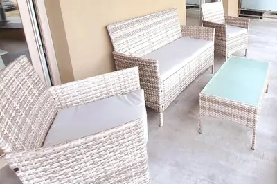 a group of wicker chairs and a table at Old Town Apartments - Kącik 18 in Kraków