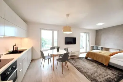 a bedroom with a bed and a table and chairs at Old Town Apartments - Kącik 60 in Kraków