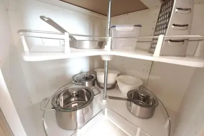 a kitchen with three pots and pans on a shelf at Old Town Apartments - Kącik 60 in Kraków