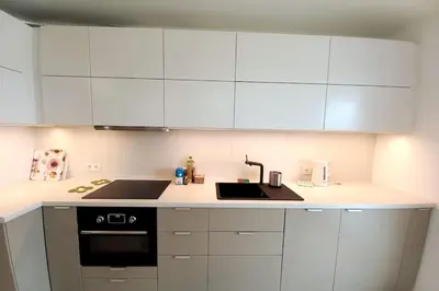 a kitchen with white cabinets and a sink at Old Town Apartments - Kącik 60 in Kraków