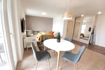 a living room with a table and chairs and a bed at Old Town Apartments - Kącik 60 in Kraków