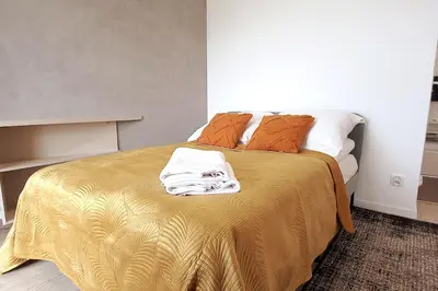 a bedroom with a bed with a gold blanket at Old Town Apartments - Kącik 60 in Kraków