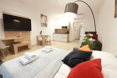 a living room with a large bed with towels on it at Old Town Apartments - B42 in Kraków