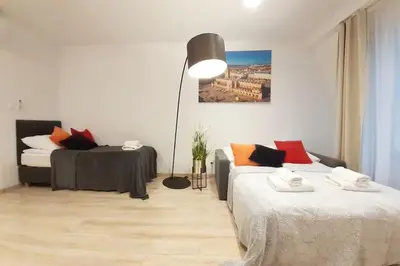 a living room with two beds and a lamp at Old Town Apartments - B42 in Kraków