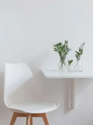 a white table with a white chair and plants on it at Studio Apartment - Radziwiłłowska 27 in Kraków