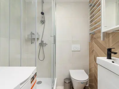 a bathroom with a shower and a toilet and a sink at Studio Apartment - Radziwiłłowska 27 in Kraków