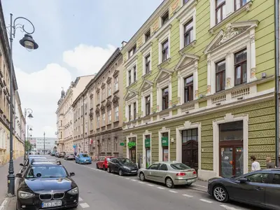 a street with cars parked on the sides of buildings at Studio Apartment - Radziwiłłowska 27 in Kraków